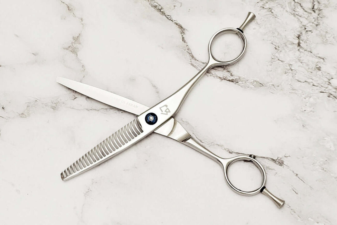 Hair thinning shears on a marble surface