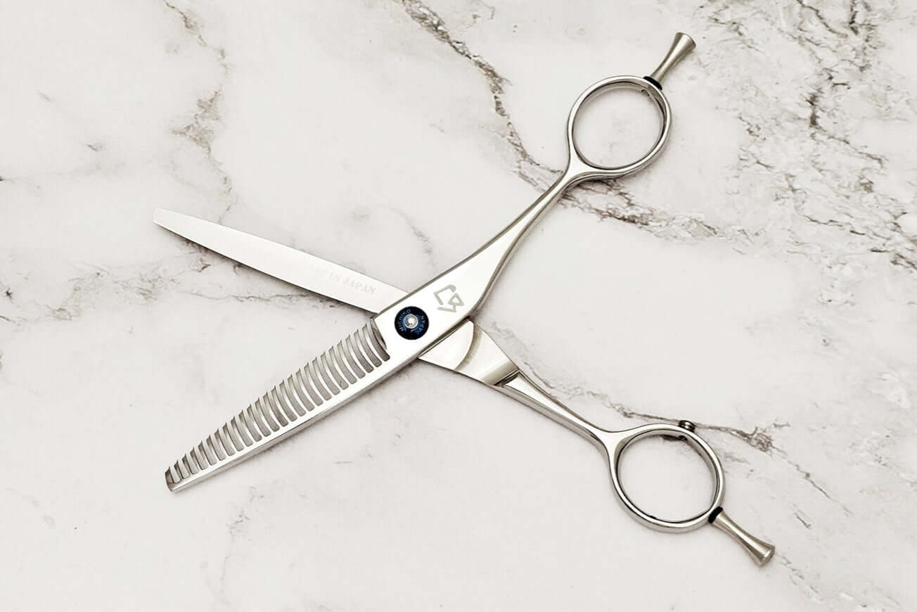 Hair thinning shears on a marble surface