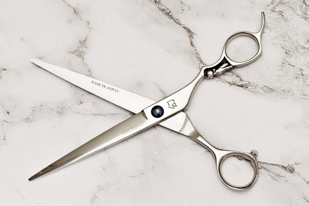 Cat handle barber shears on a marble surface