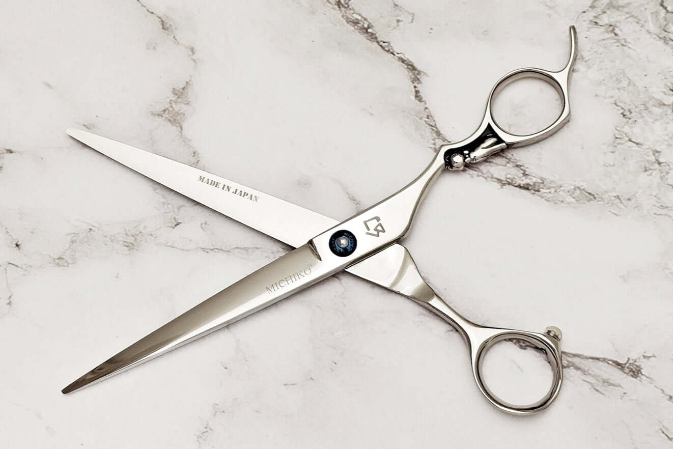 Cat handle barber shears on a marble surface