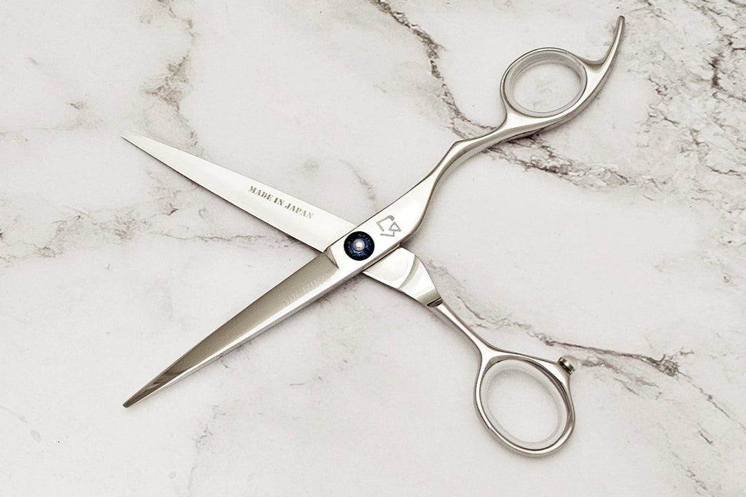 Pair of Michiko Select scissors on a marble surface in open position.