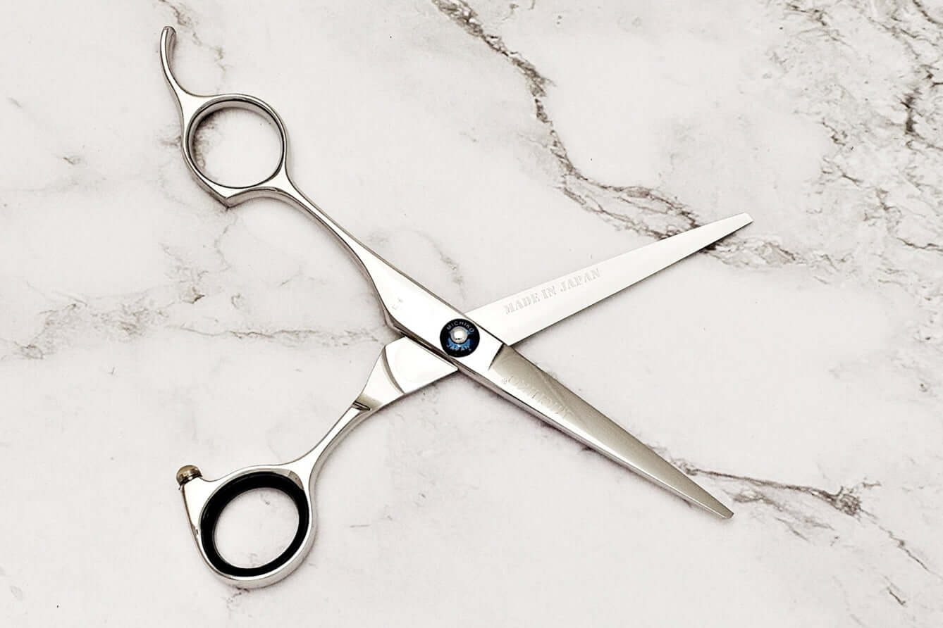 Lefty hair cutting scissors on a marble surface