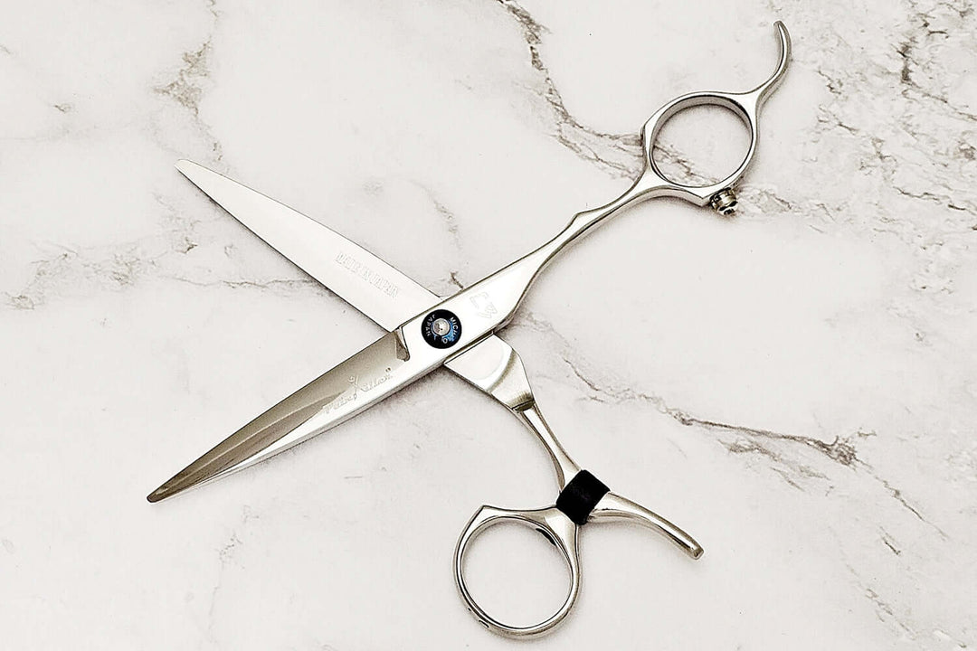 Swivel hair scissors on a marble surface