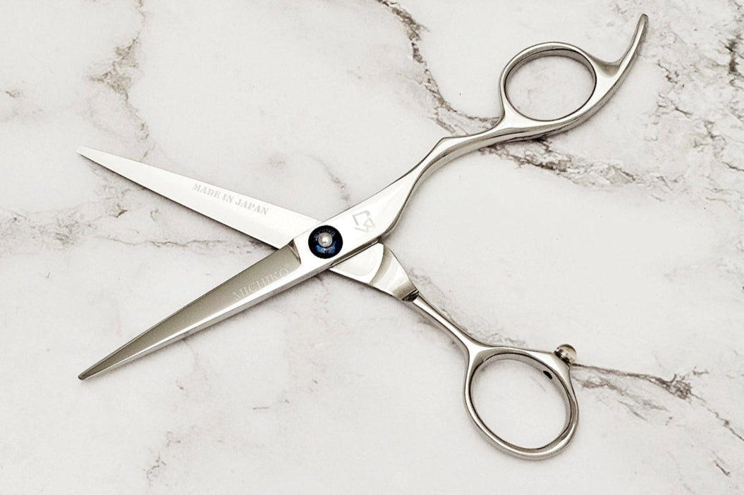 Michiko Select MK 5.5 Hair scissors on a marble surface in open position.