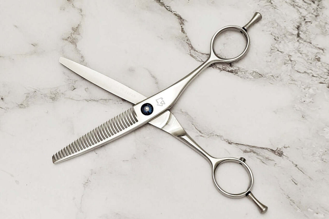 Hair thinning shears on a marble surface