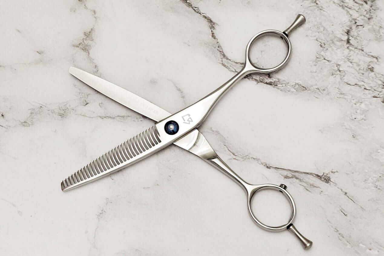 Hair thinning shears on a marble surface