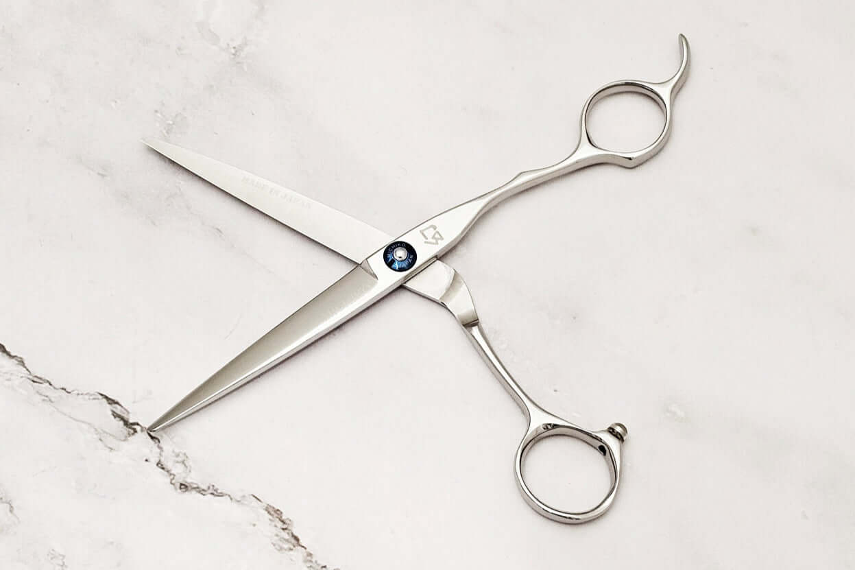 Hair cutting shears on a marble surface