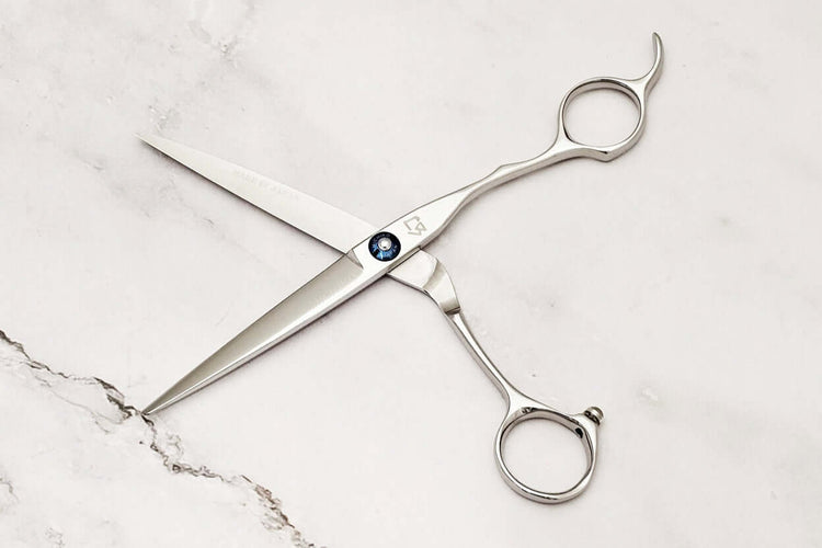 Hair cutting shears on a marble surface