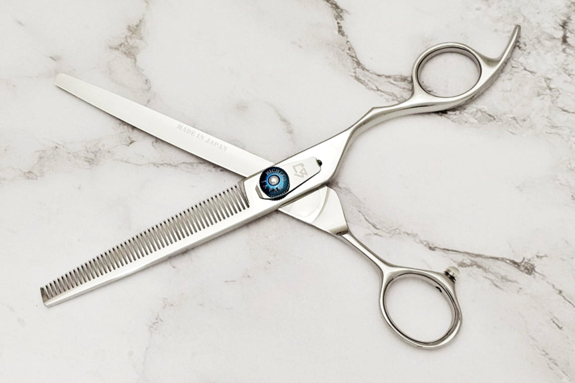 Hair cutting shears on a marble surface