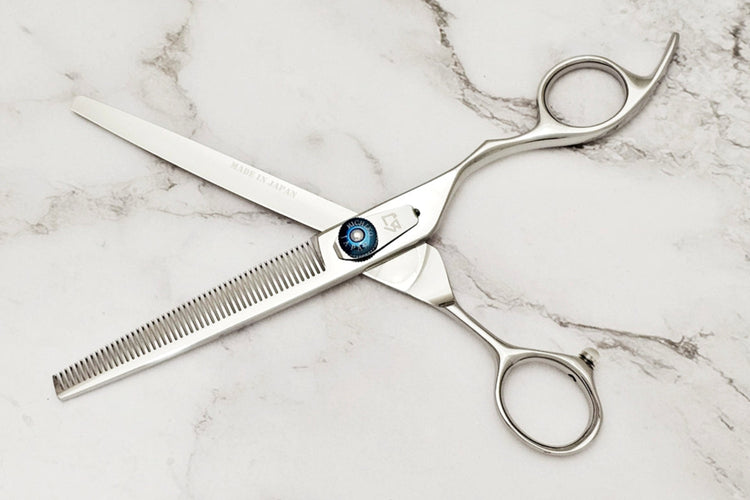 Hair cutting shears on a marble surface