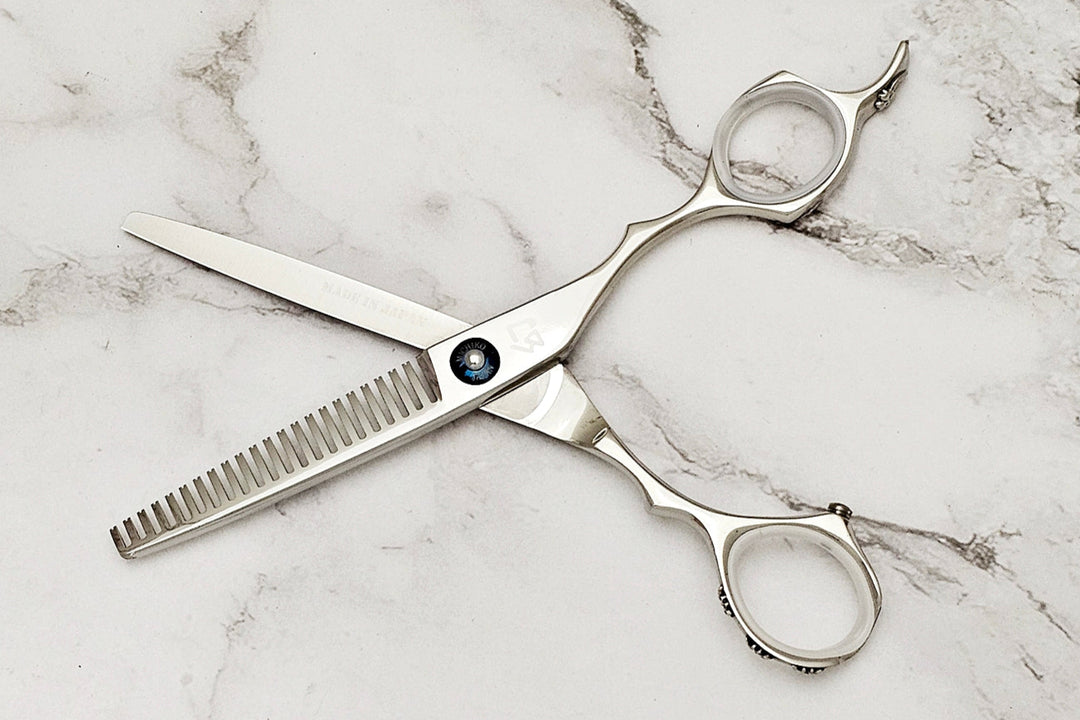 Hair thinning shears on white marble background