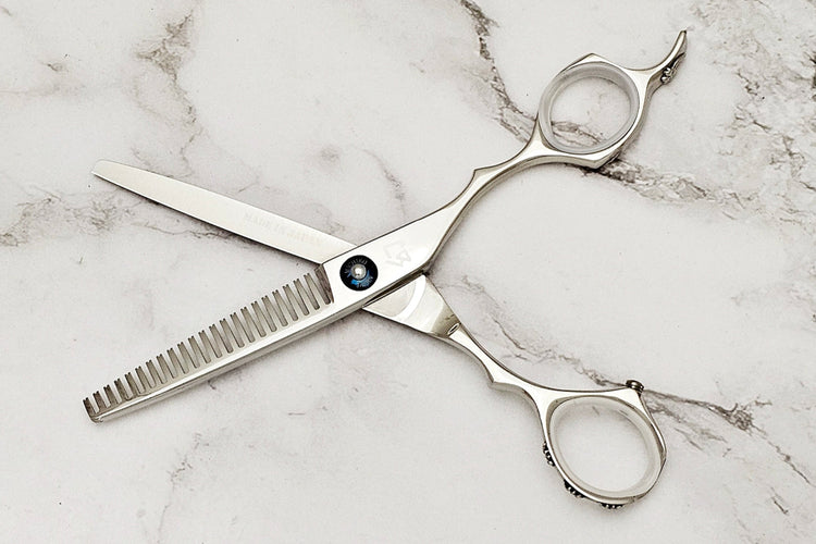 Hair thinning shears on white marble background