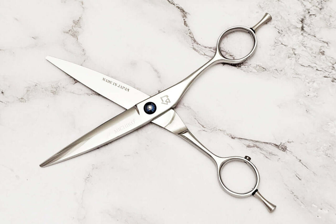 Slide cutting hair scissors on a marble surface