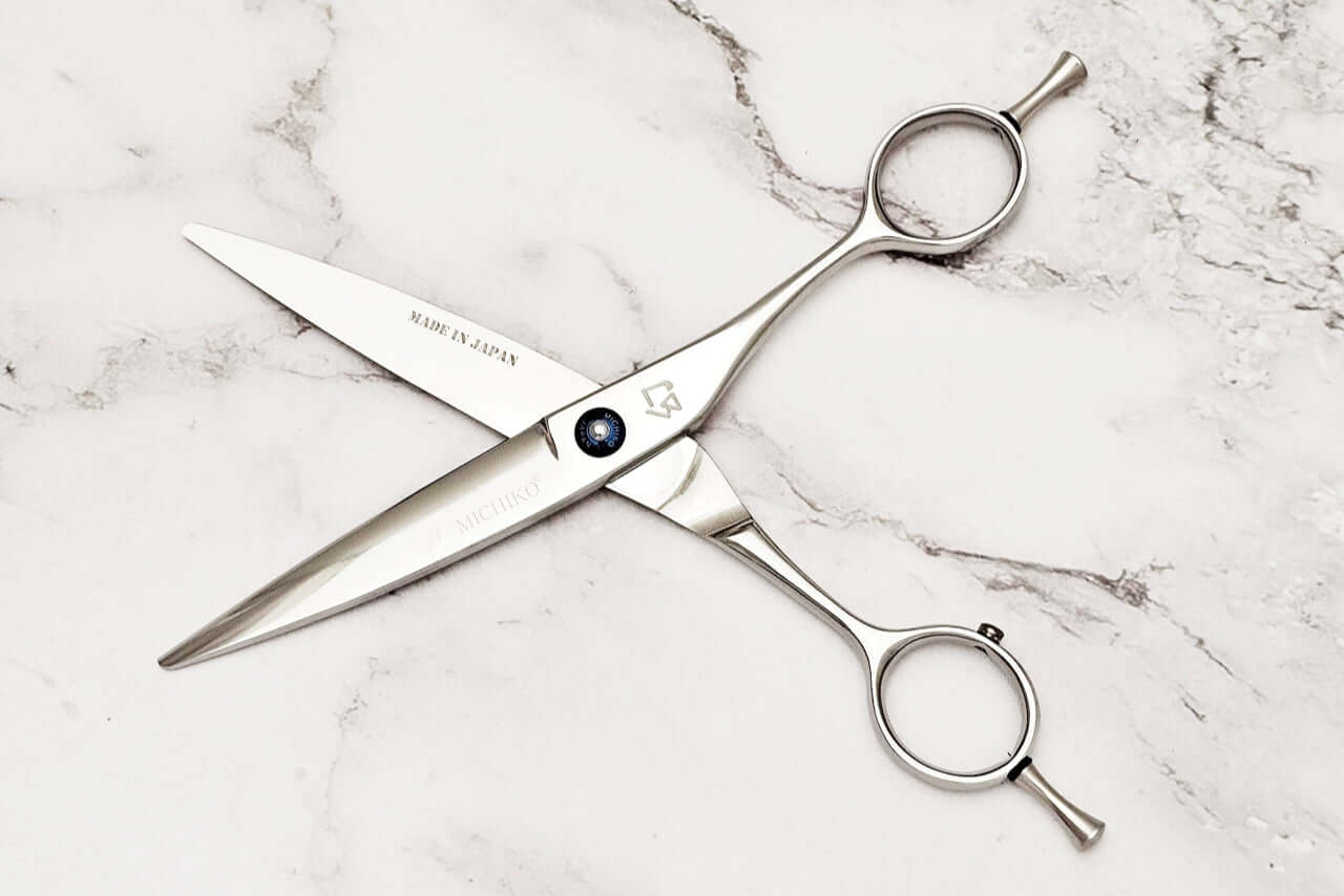 Slide cutting hair scissors on a marble surface