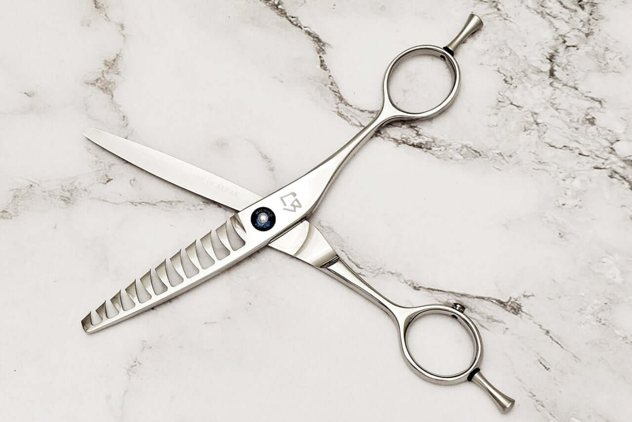 Reversible hair texturizing scissors on a marble surface