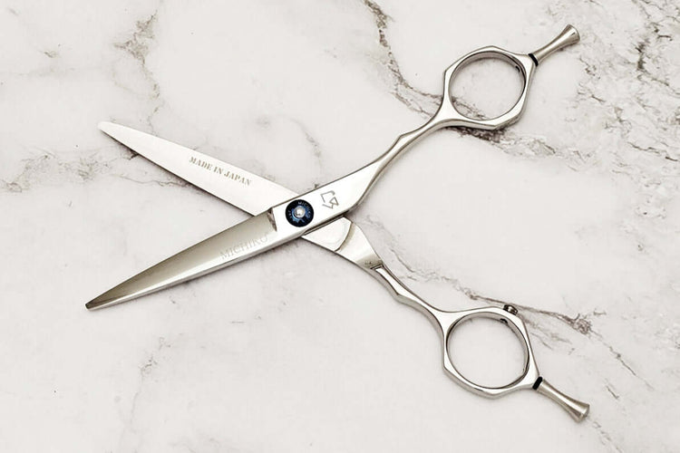 Hair shears on a marble surface