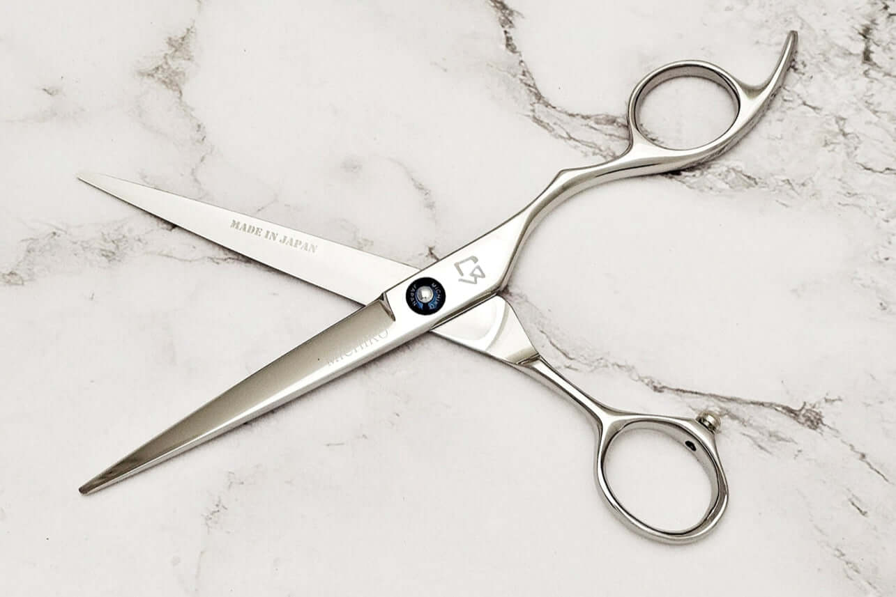 KT 6.5" barber shears on a marble surface