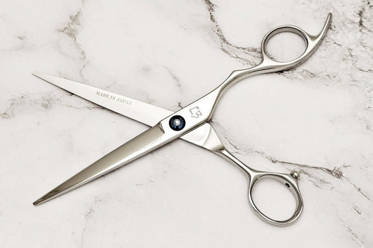 KT 6.5" barber shears on a marble surface