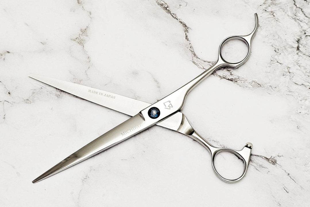 Barber shear on a white marble background
