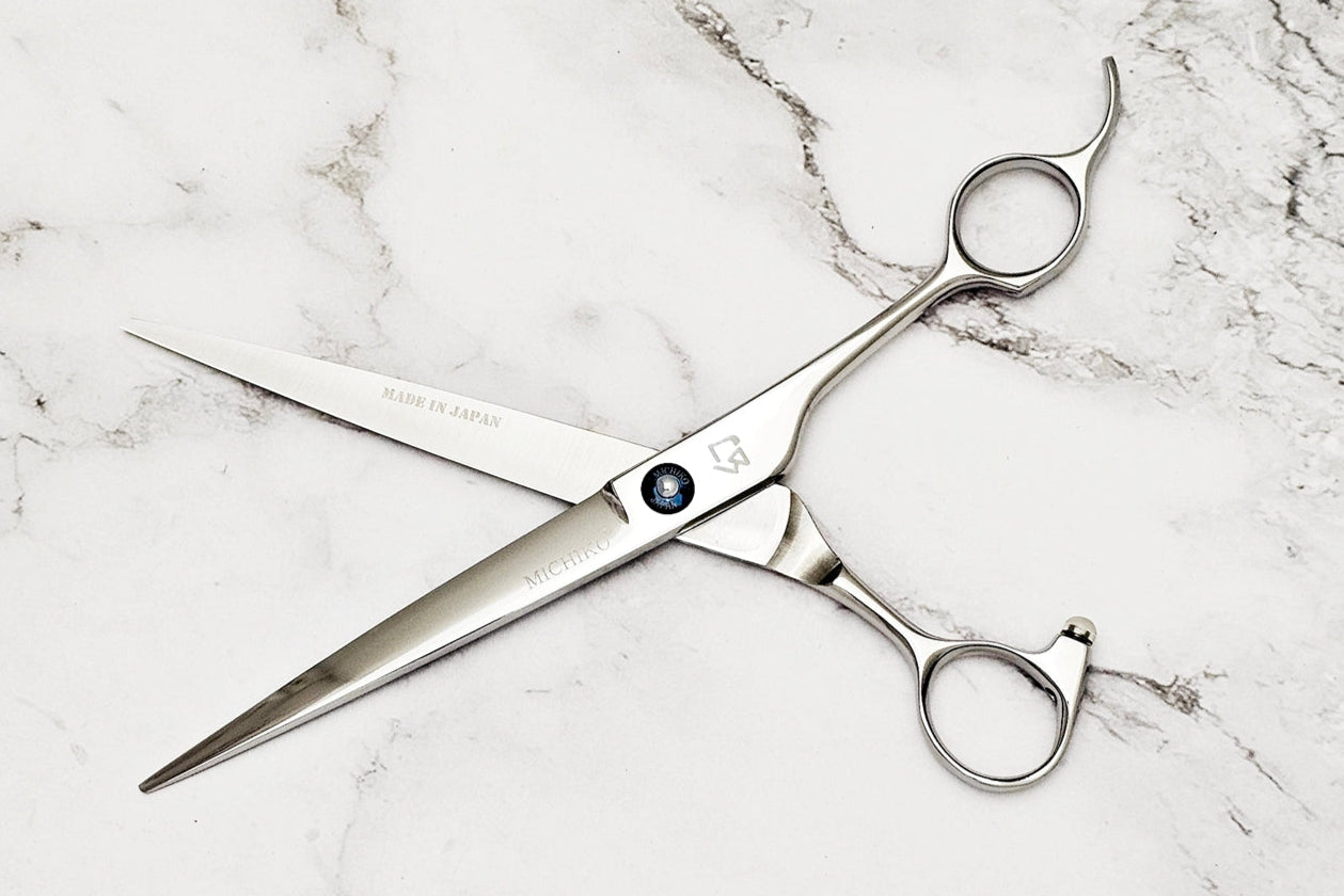 Barber shear on a white marble background
