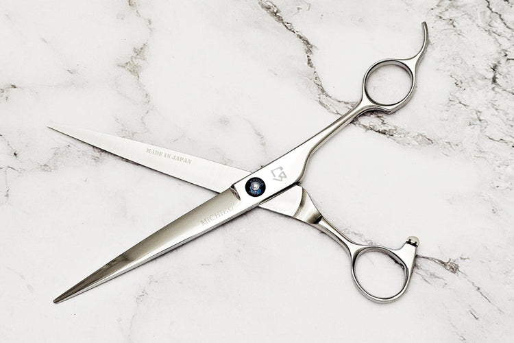 Barber shear on a white marble background