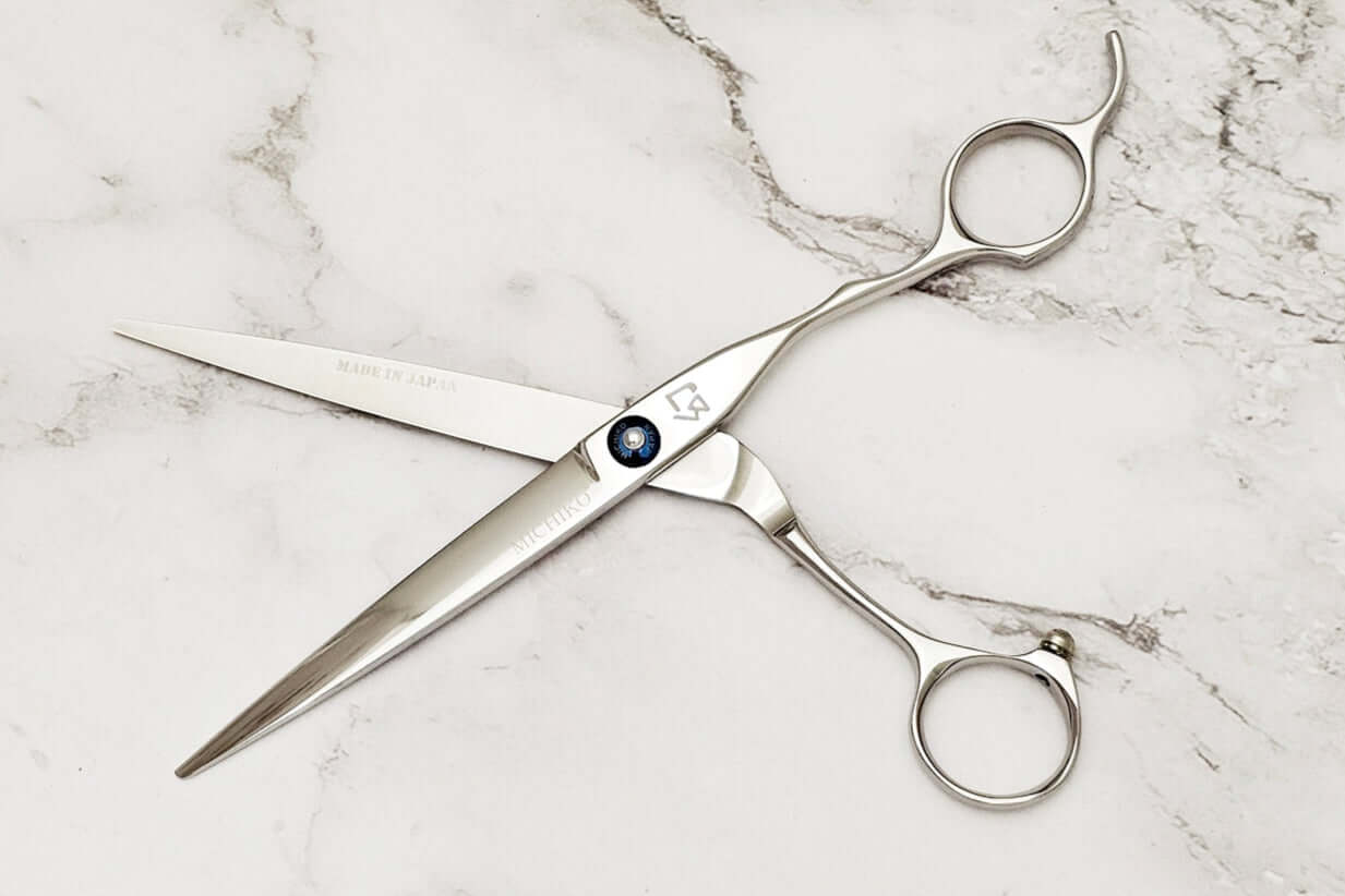 Hair shears on a marble surface