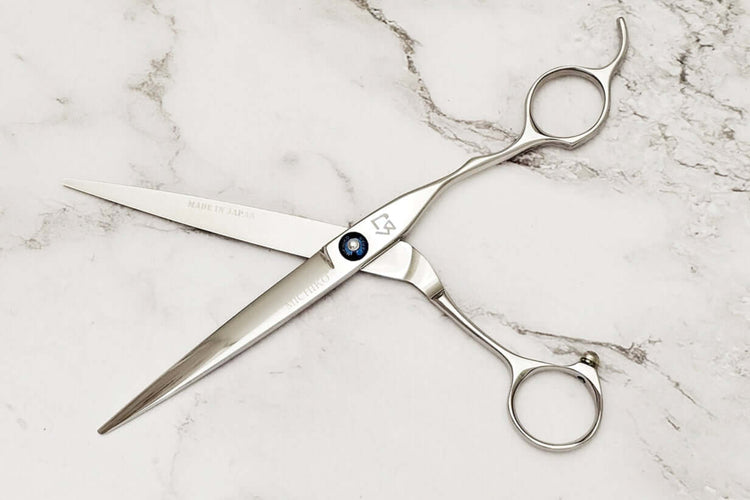 Hair shears on a marble surface