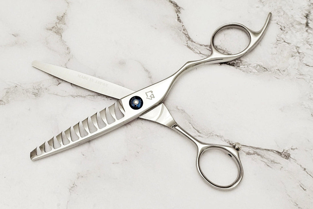 Silver scissors on a marble surface