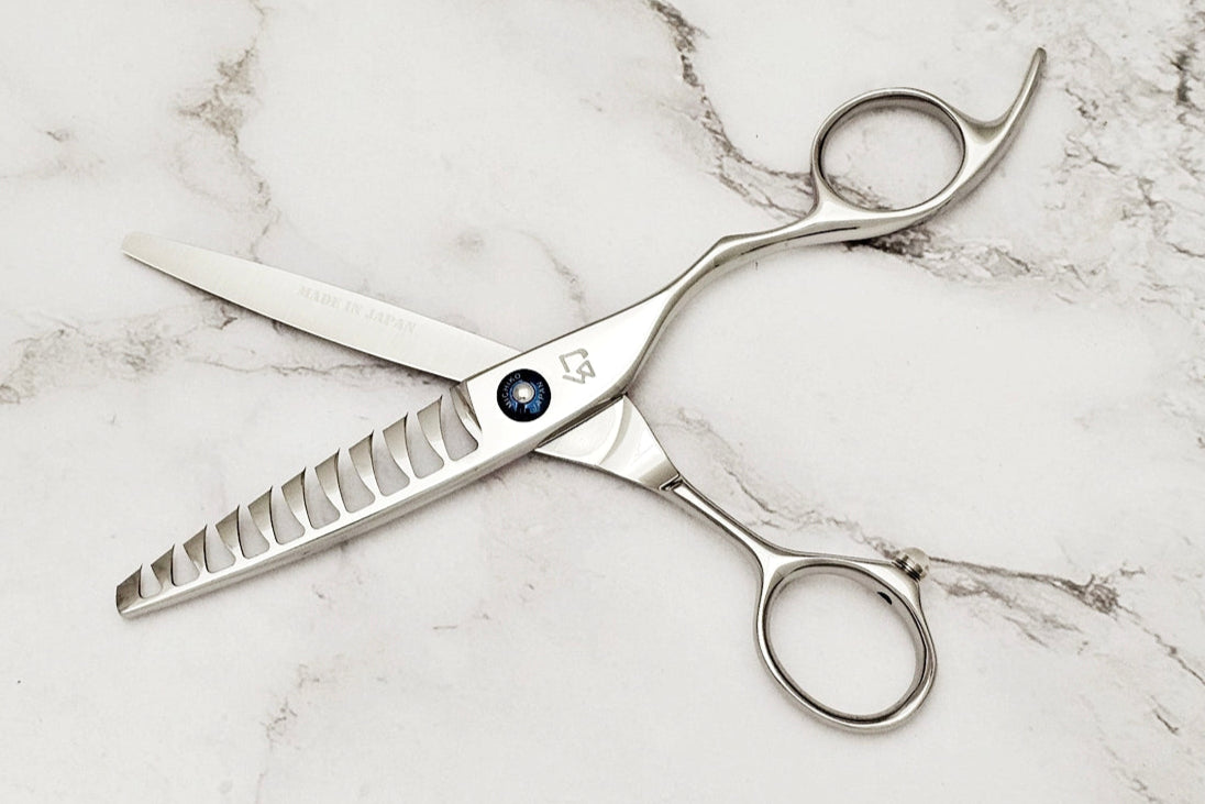 Silver scissors on a marble surface