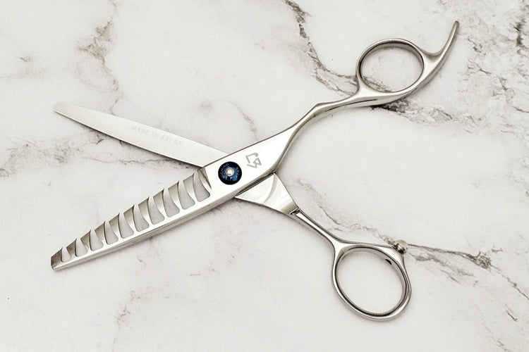 Silver scissors on a marble surface