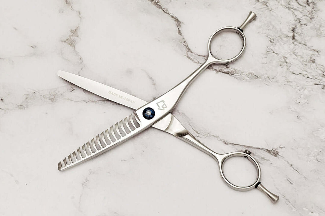 Reversible hair texturizing shears on a marble surface