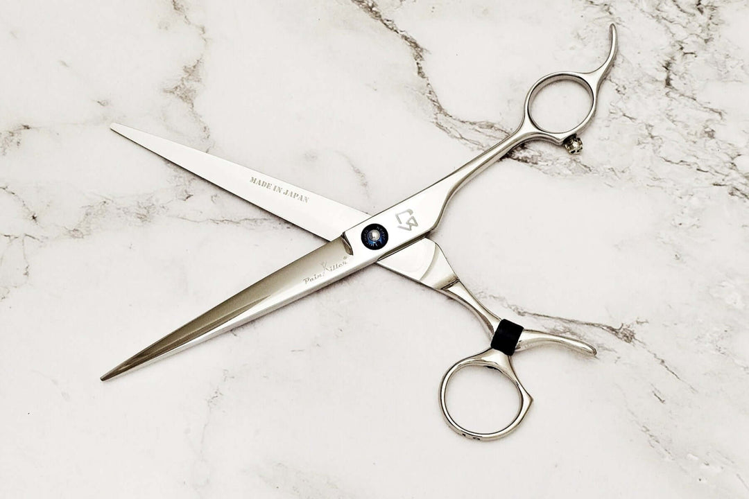 Swivel barber shears on a marble surface