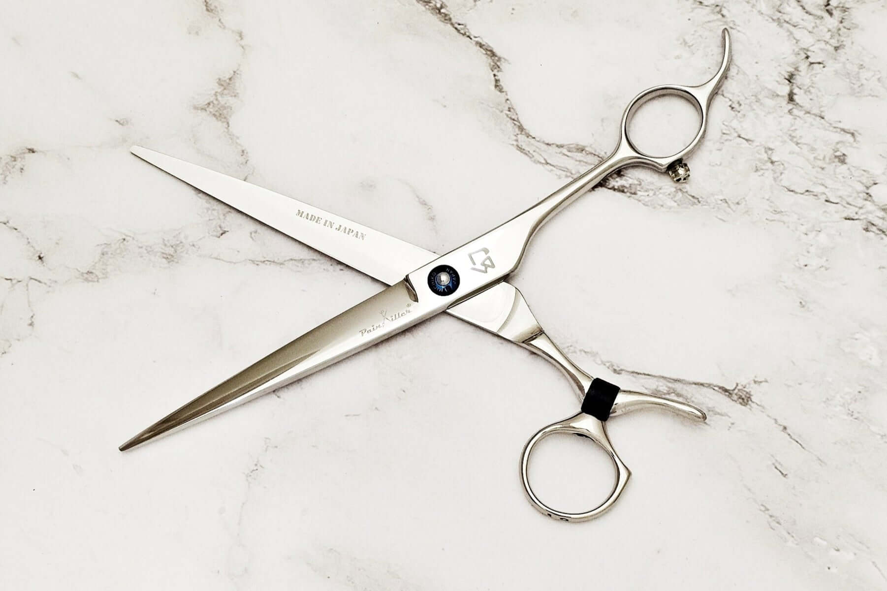 Swivel barber shears on a marble surface