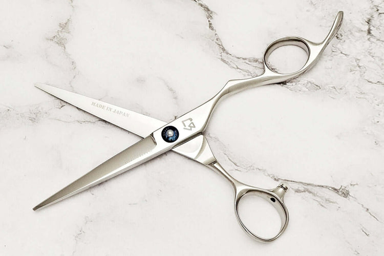 KM 6.0" hair shears on a marble surface 