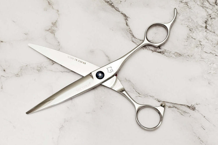 Hair scissors on a marble surface