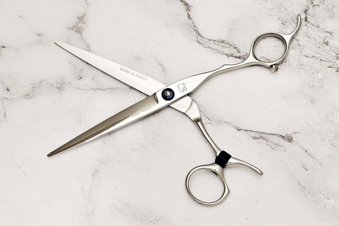 Swivel hair scissors on a marble background