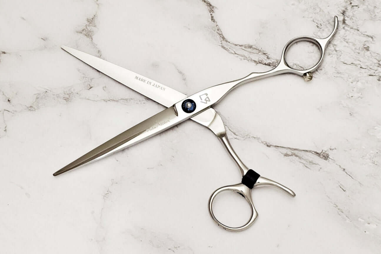 Swivel hair scissors on a marble background