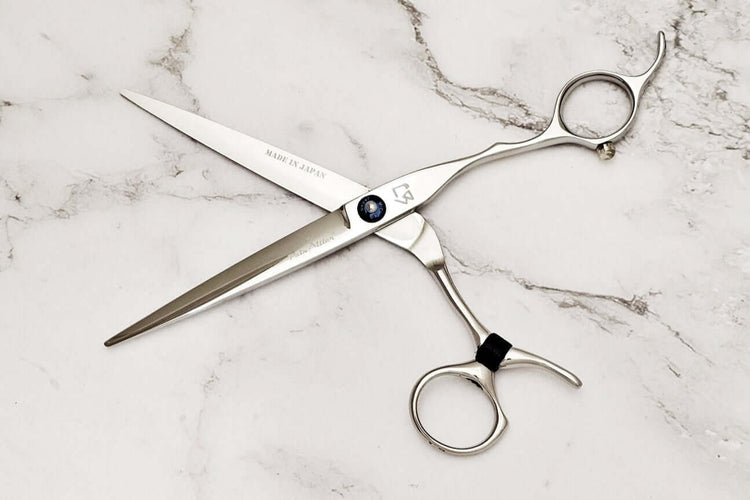 Swivel hair scissors on a marble background