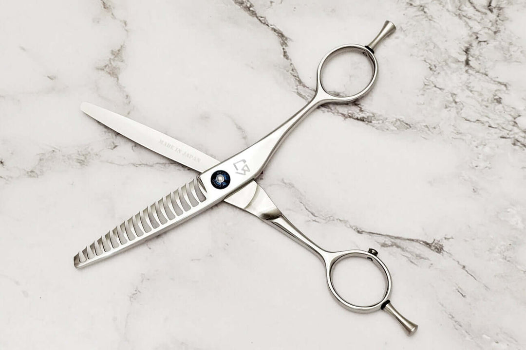 Reversible hair texturizing shears on a marble surface