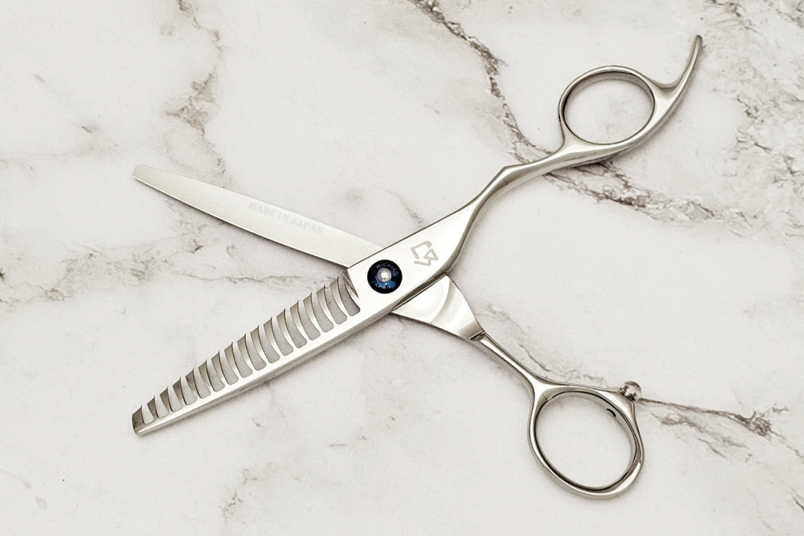 Hair cutting shears on a marble surface