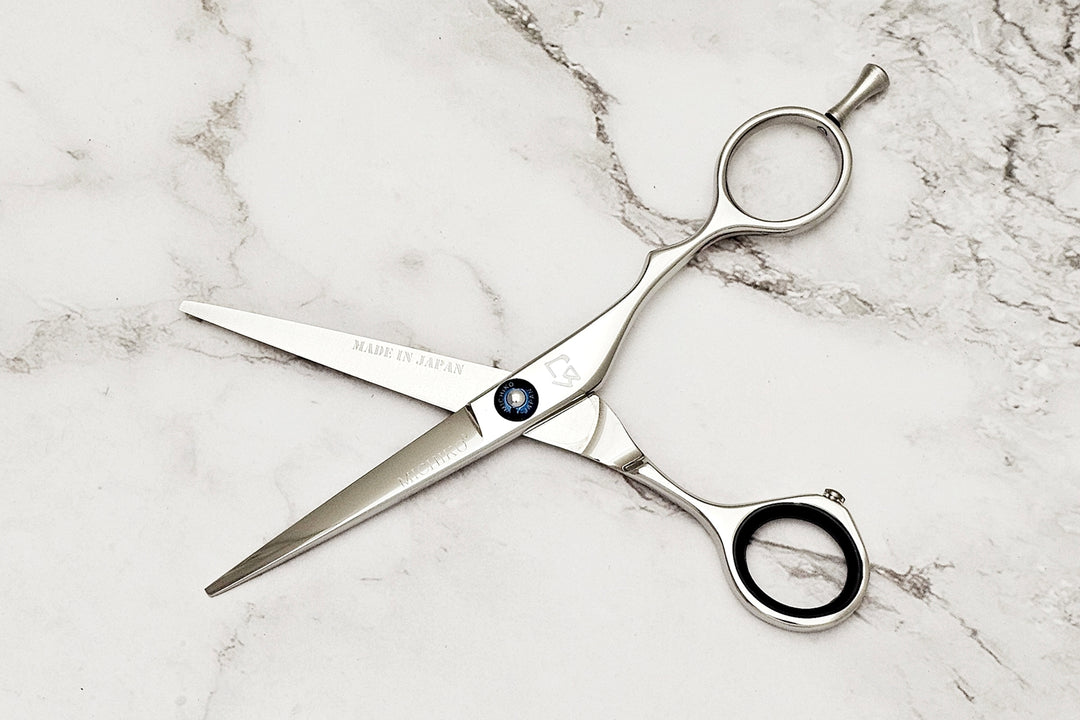Hair shears on a marble surface