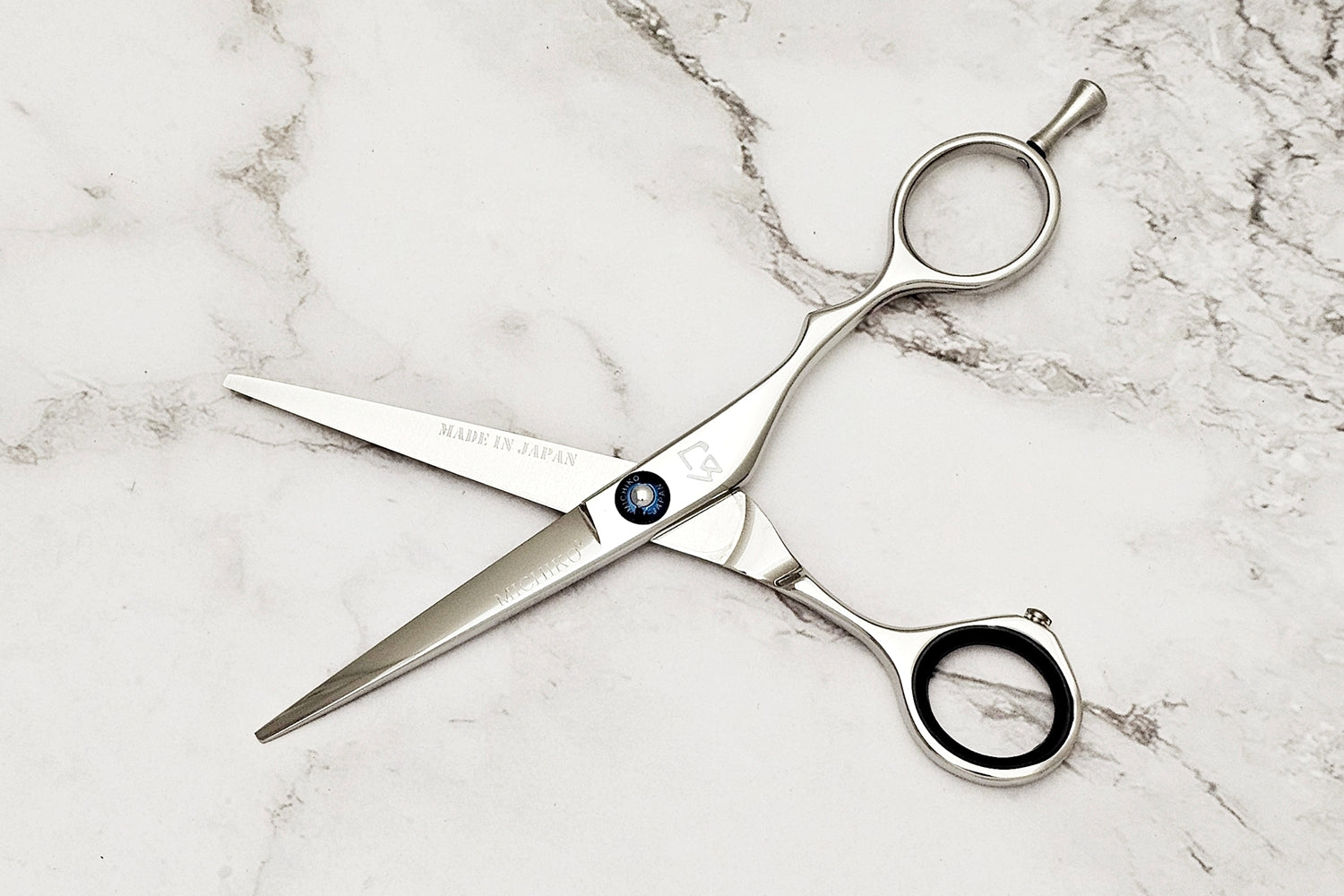 Hair shears on a marble surface