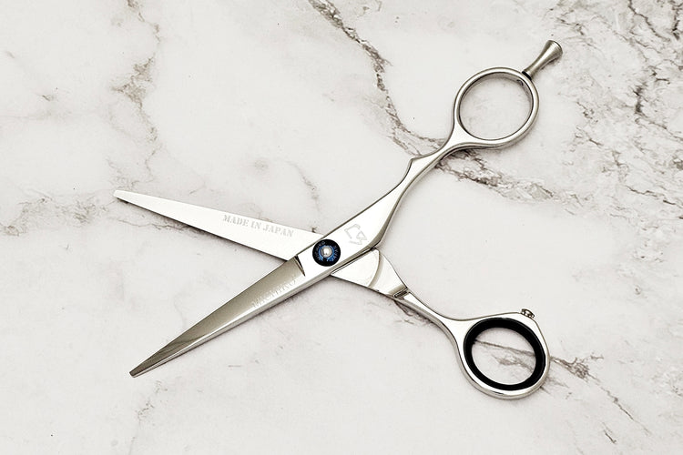 Hair shears on a marble surface