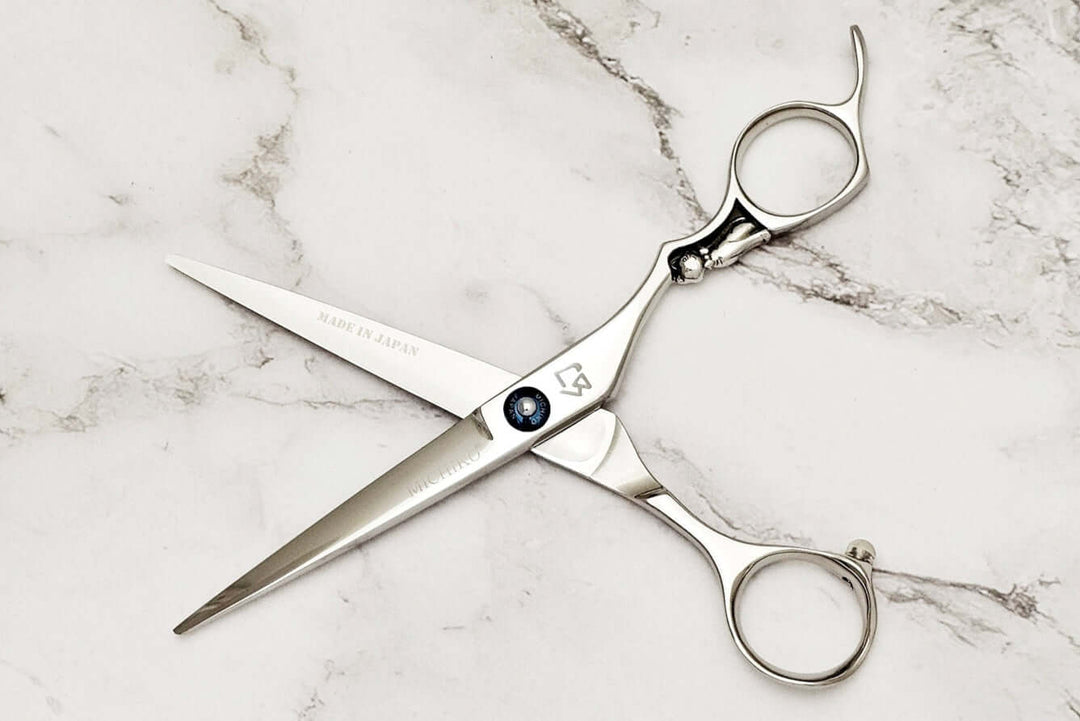 Cat design handle hair cutting scissors on a marble surface