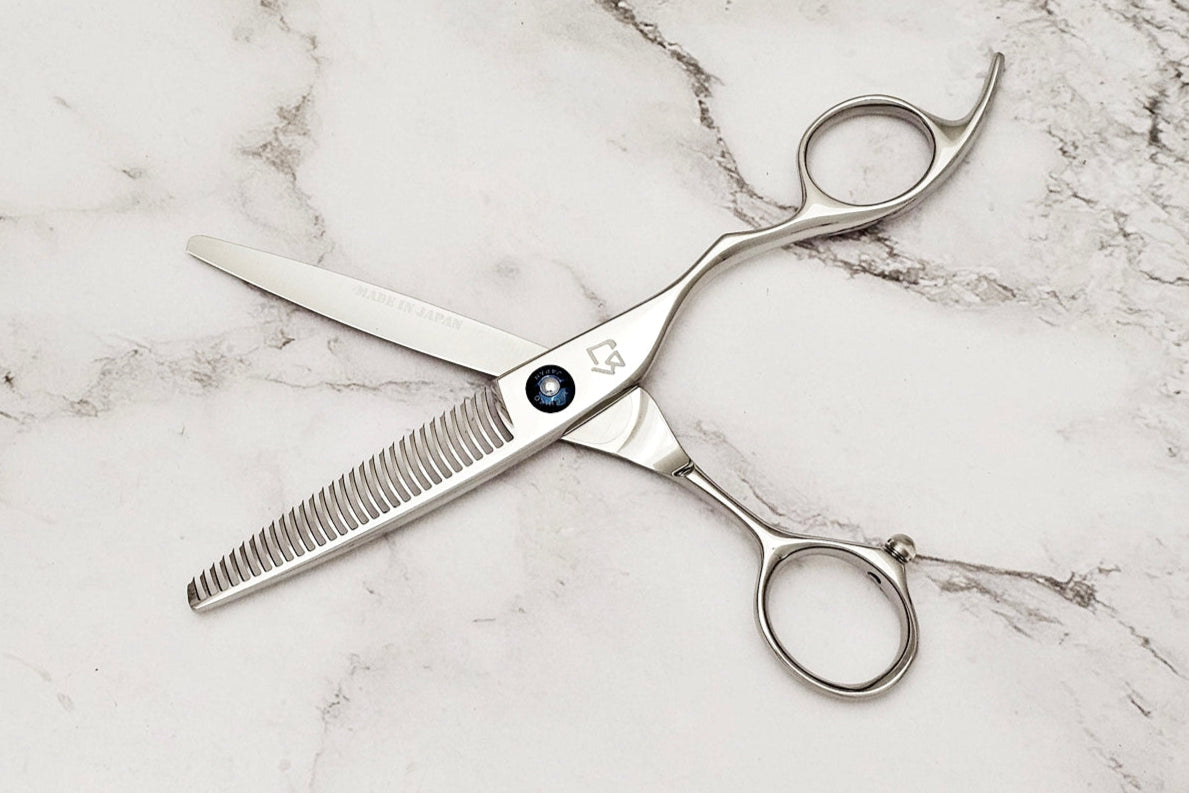 Hair cutting shears on a marble surface