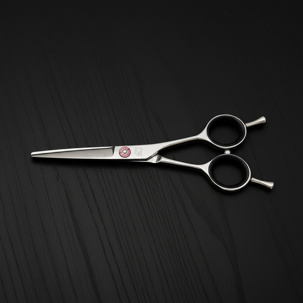 Hair cutting scissors with pink screw on a white background