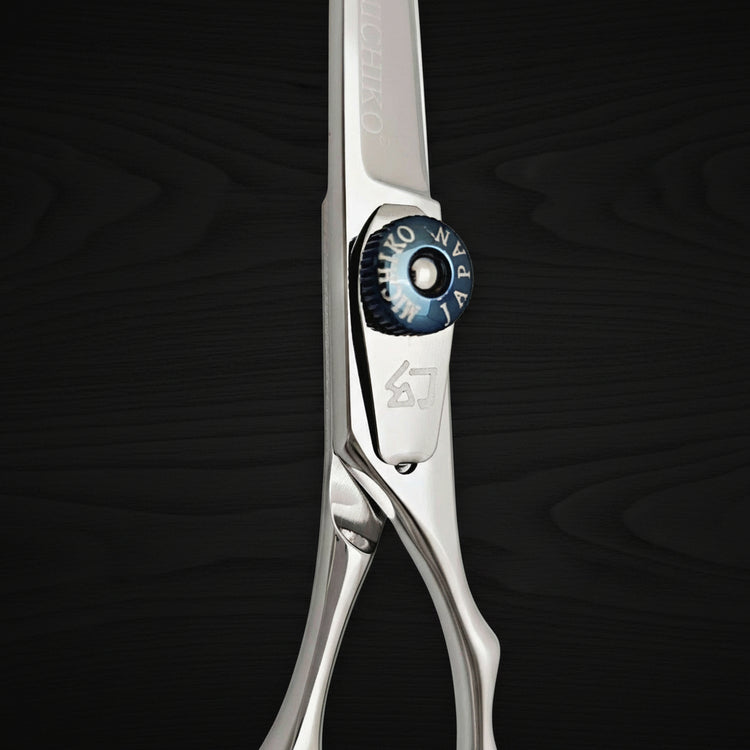 Hair shears with a brand logo on a black background