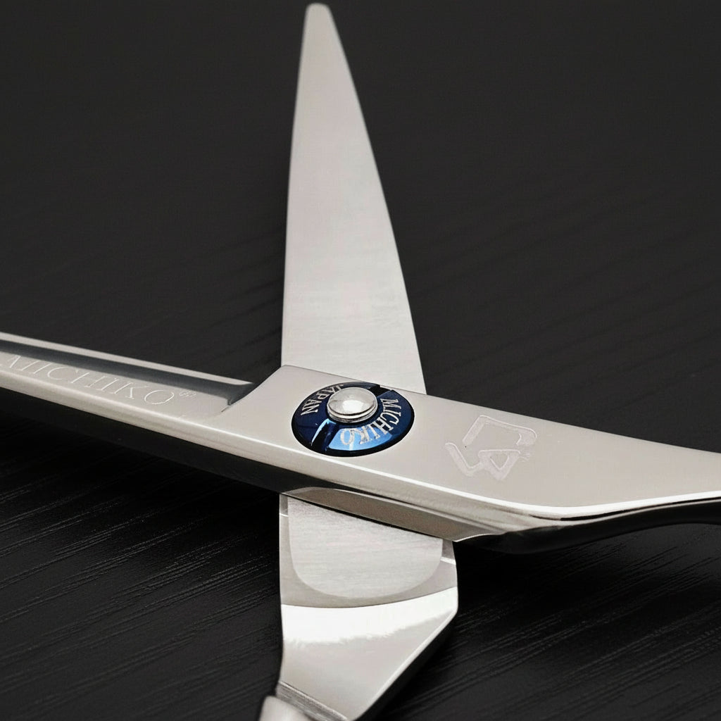 Close-up of a pair of hair scissors with a visible brand logo on a black oak textured background