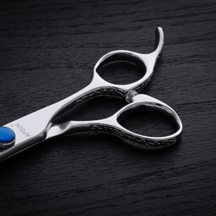 Hair thinning shears on a black background.