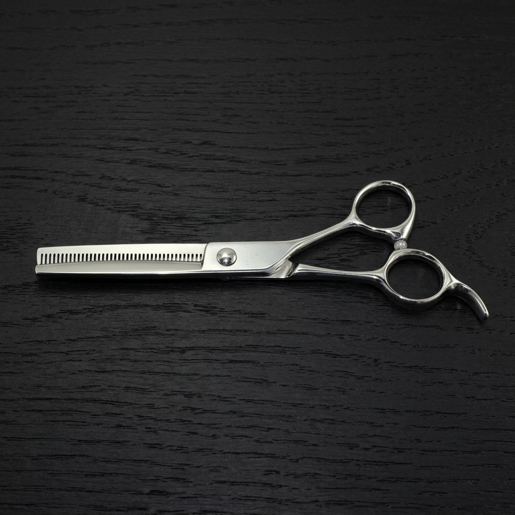 Barber thinning scissors on a black background.